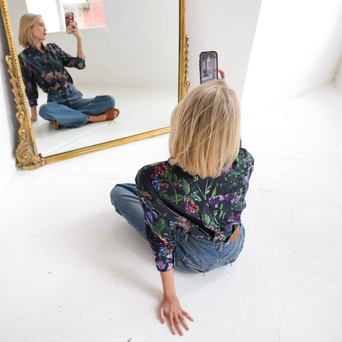 woman wearing floral shirt taking selfie