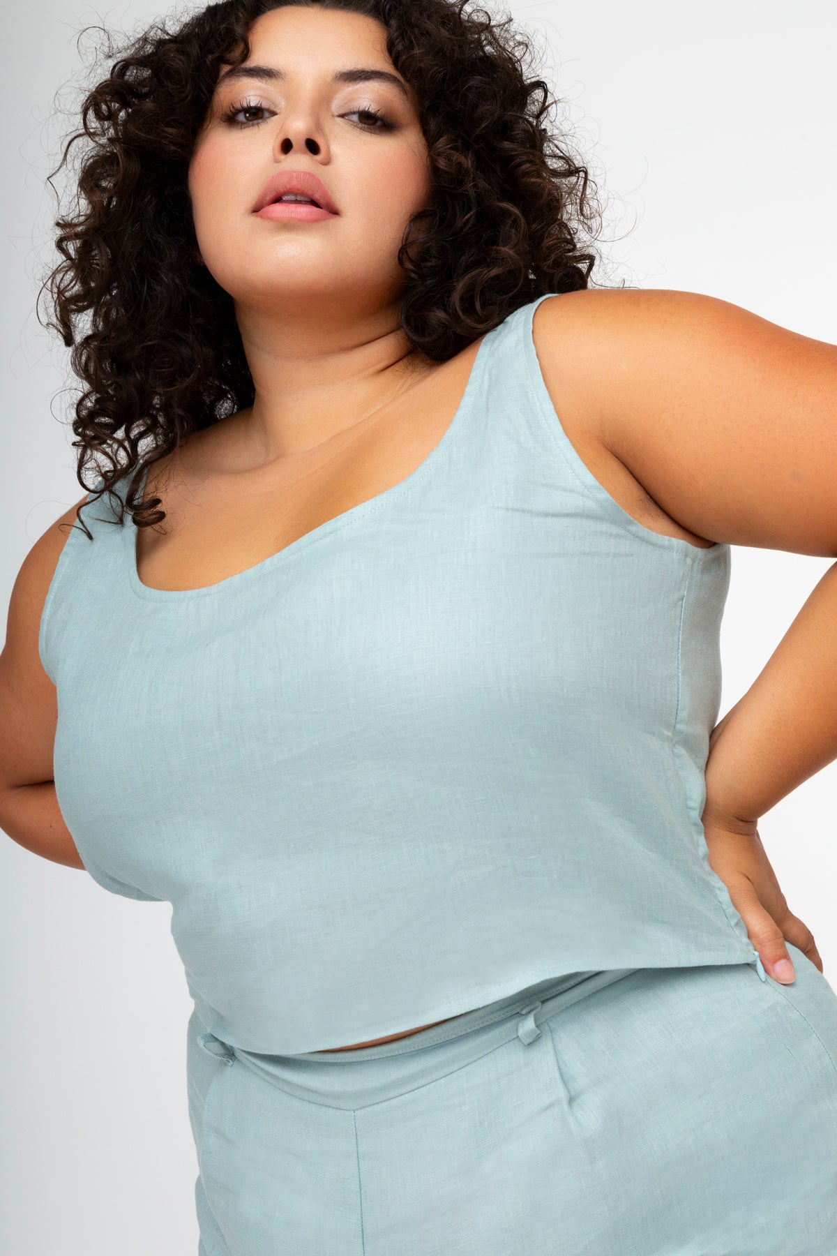 Blue linen tank top paired with blue linen shorts for plus sized or extended sizing.