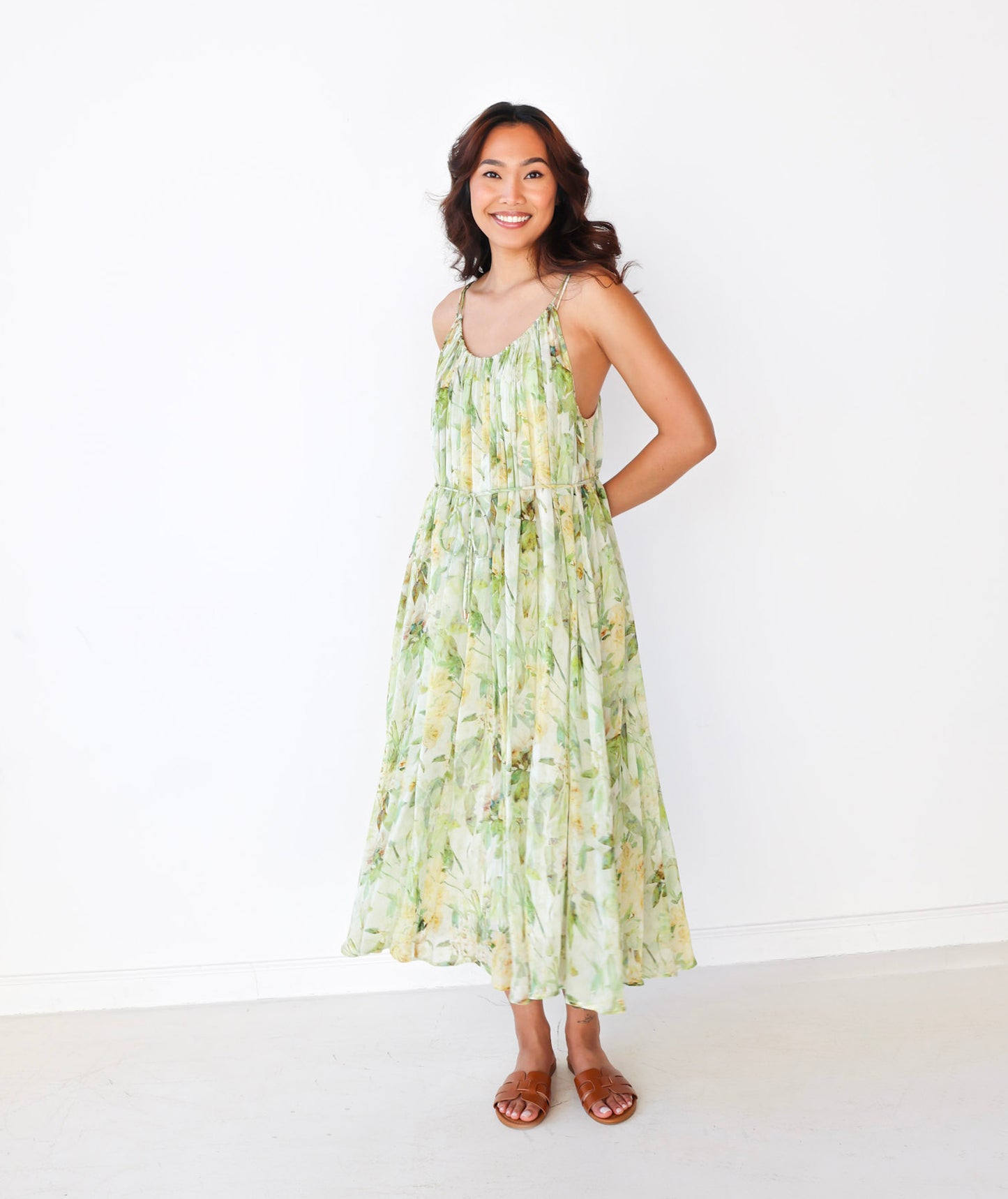 Woman wearing a floral dress on a white background
